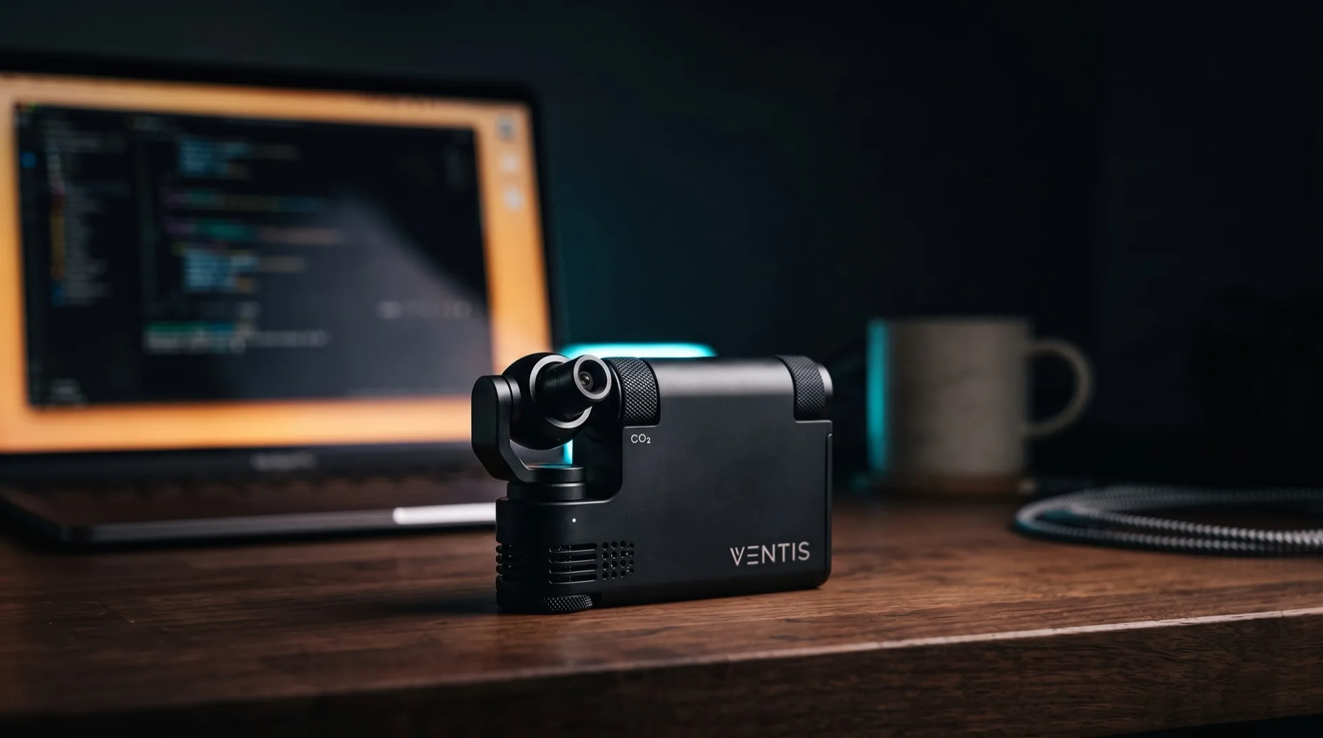 VENTIS desktop CO₂ blaster venting a burst of vapor beside a MacBook