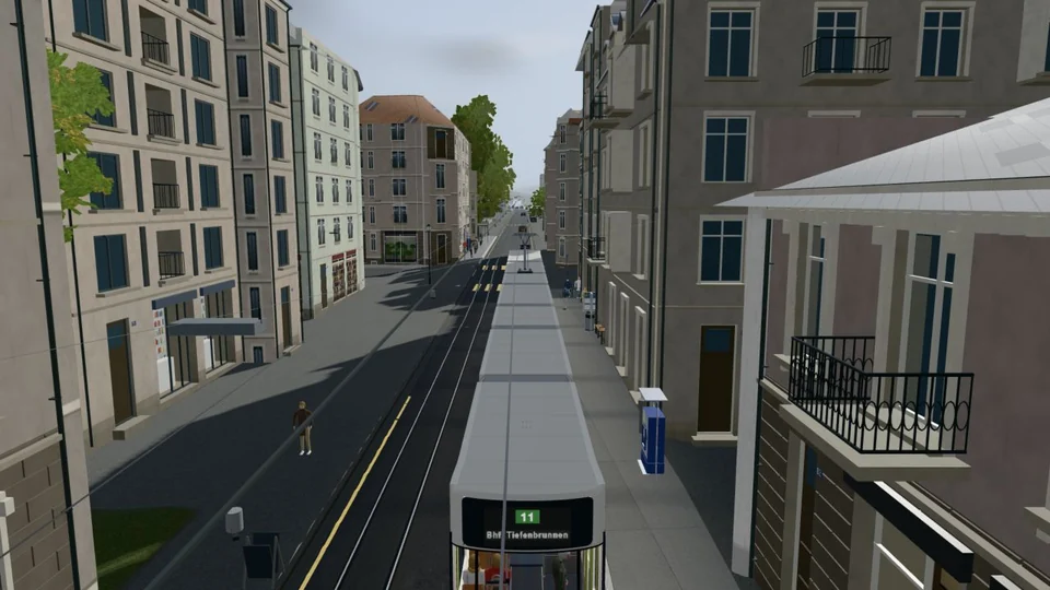 Heute: Feldeggstrasse von hinten über dem Tram mit Wohnhäusern, Balkonen, Läden und Gleisen